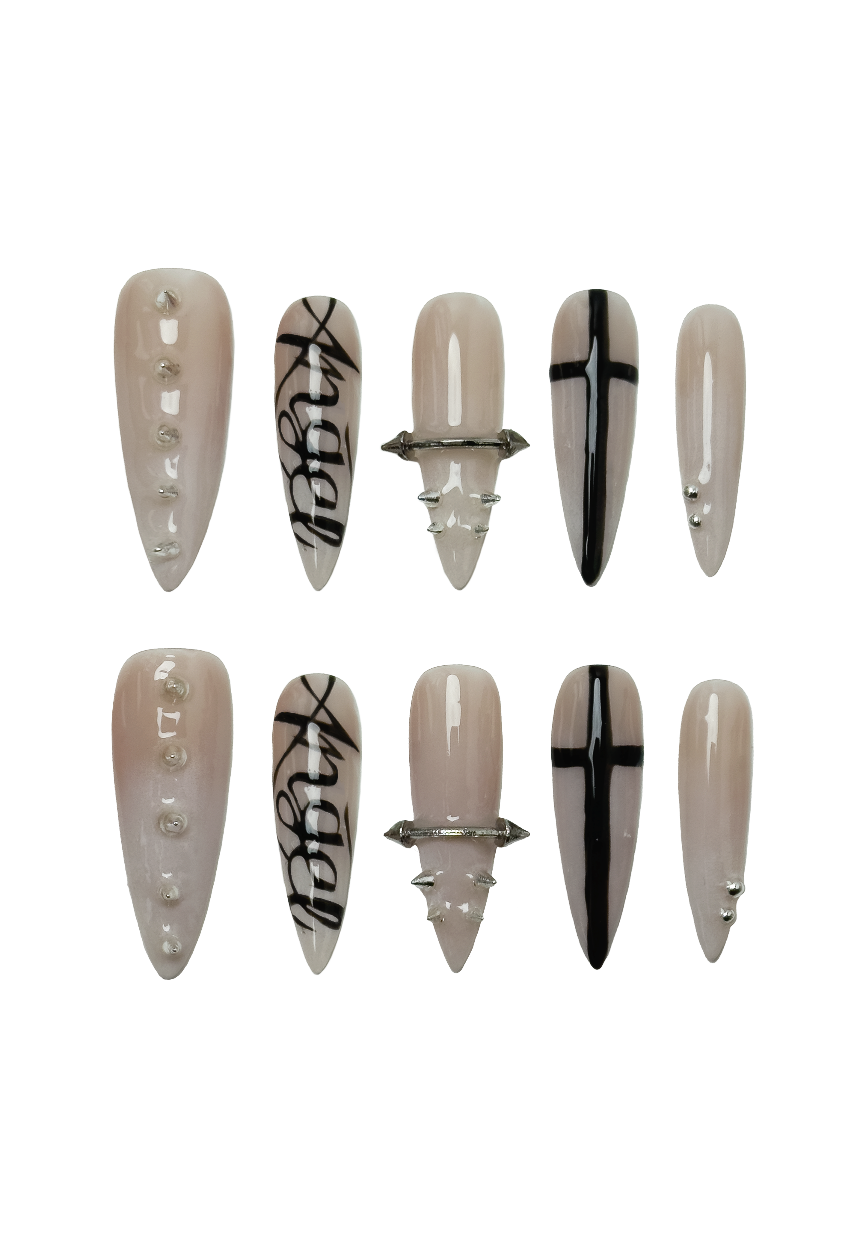 Set of long stiletto-shaped nude press-on nails with silver chrome studs, black gothic typography, and cross motifs. Features brutalist nail art with edgy glam detailing for alternative fashion styles.